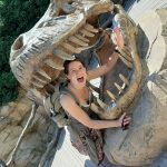 Photograph of Jo Jarrett posing inside a model dinosaur's mouth