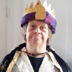 A photograph of a man dressed up as a king
