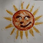 A painting of a yellow, red and orange sun with a smiley face