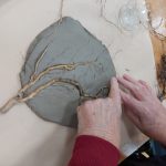 Hands making plaster sculptures or roots