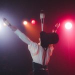 circus performer balancing juggling sticks