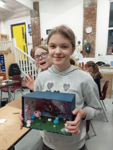 Young girl showing off diorama 