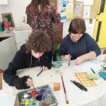 Young art students painting pictures