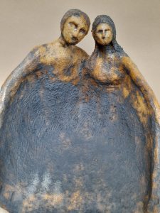 A ceramics artwork depicting 2 people
