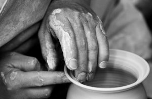 Close up of hand turning a pot on a potter's wheel